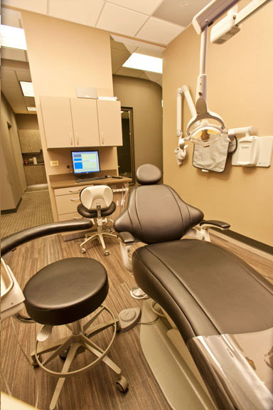 Dental office interior with equipment and a chair.